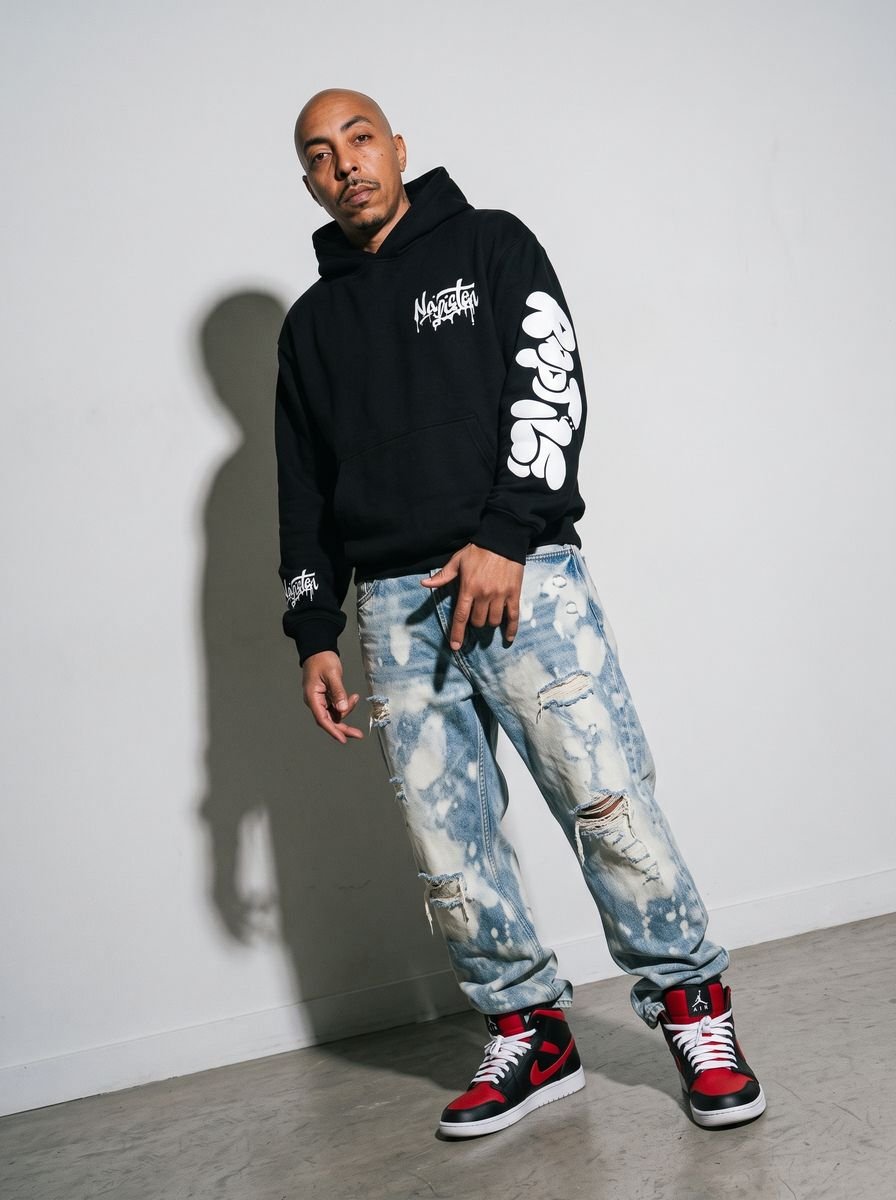 Black zip-up hoodie styled in a studio editorial
