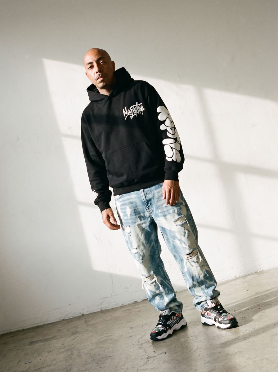 Black zip-up hoodie styled in a studio editorial