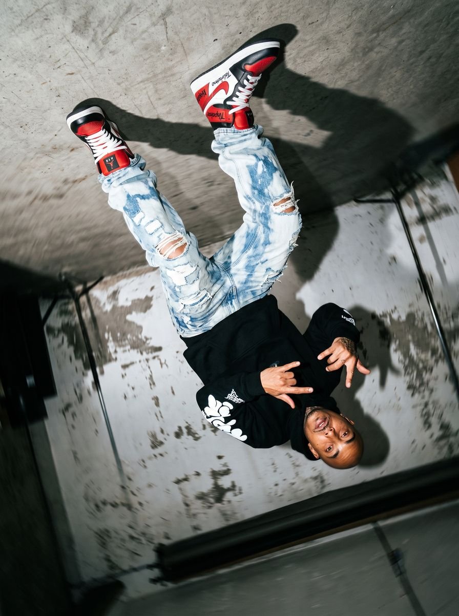 Black zip-up hoodie styled in a studio editorial