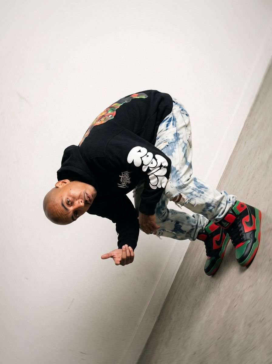 Black zip-up hoodie styled in a studio editorial