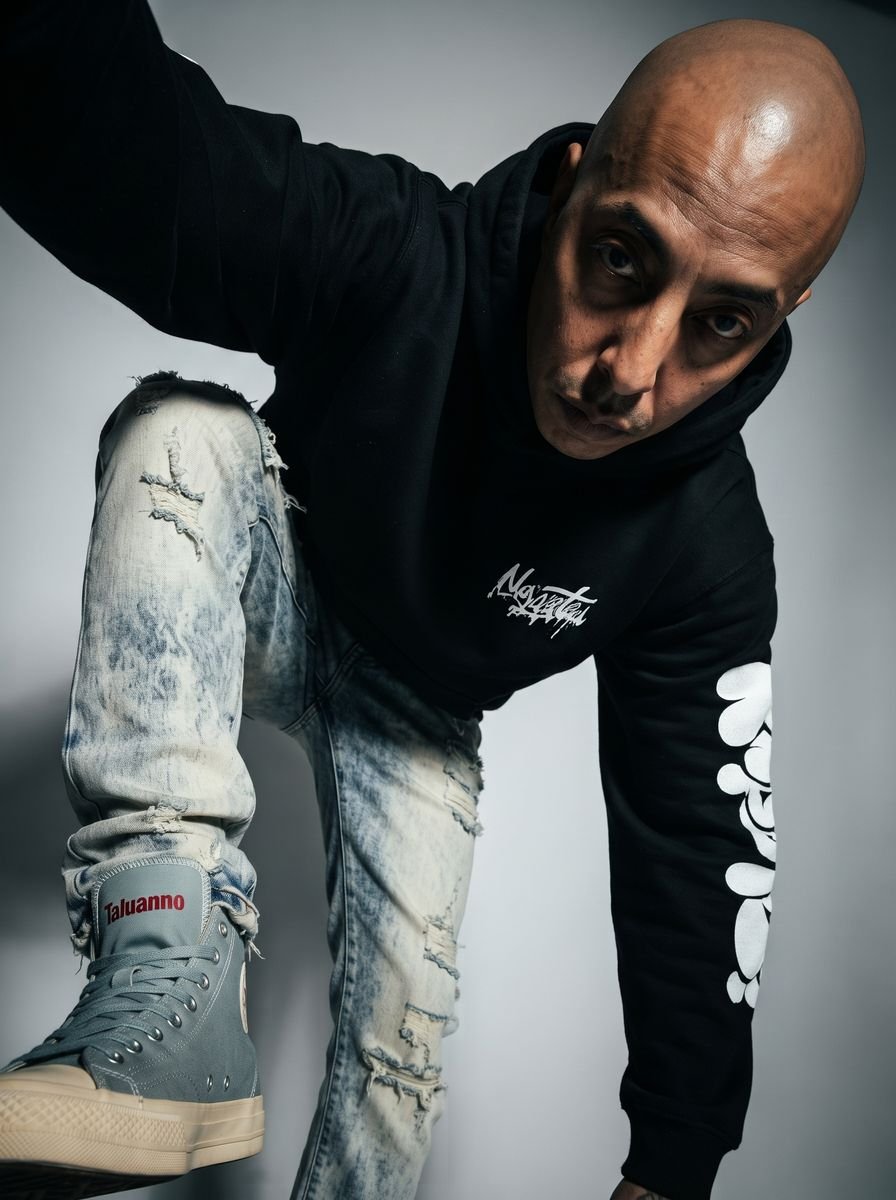 Black zip-up hoodie styled in a studio editorial