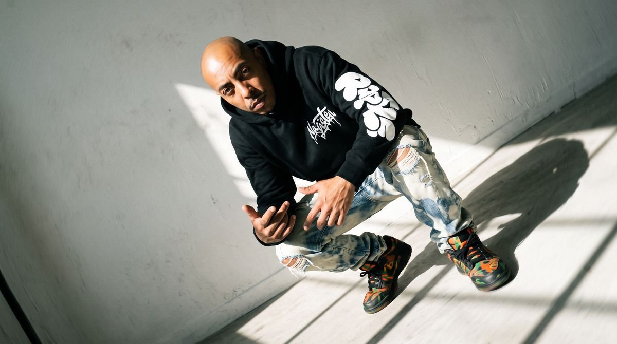 Black zip-up hoodie styled in a studio editorial